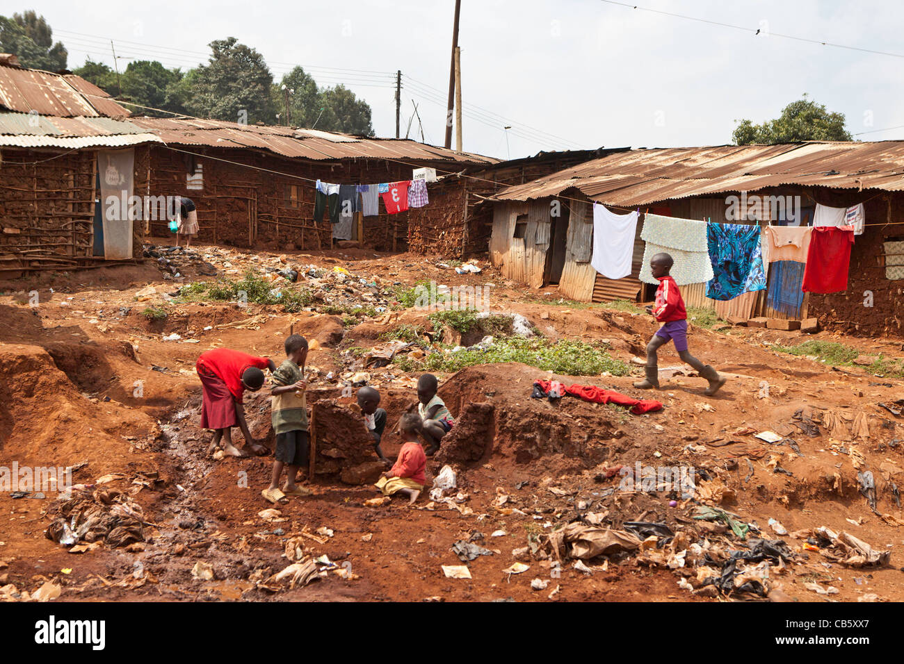 Children playing on a small section of spare land deep inside Kibera Slum, Nairobi, Kenya Stock Photo