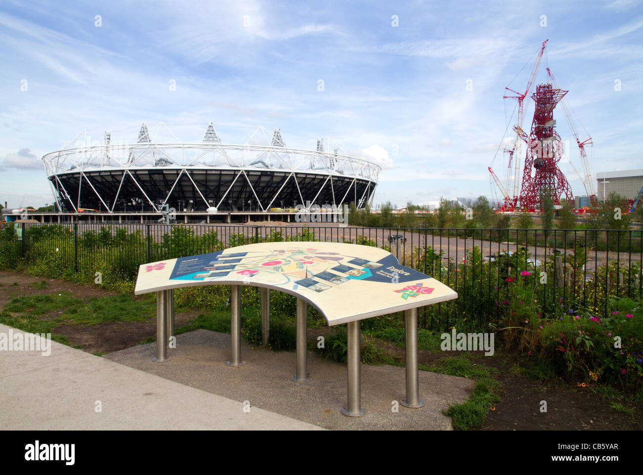 The London 2012 Olympic stadium, the ArcelorMittal Orbit observation tower and site map in the Olympic Park in Stratford, London Stock Photo