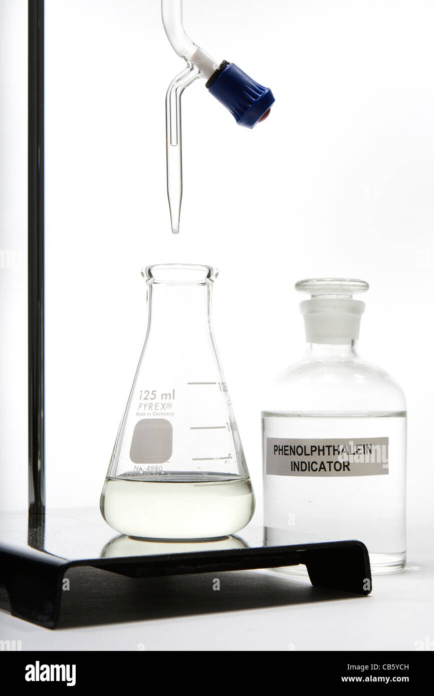 Base titrated into acid containing phenolphthalein as an indicator of pH.  See also CB5YCR. Stock Photo