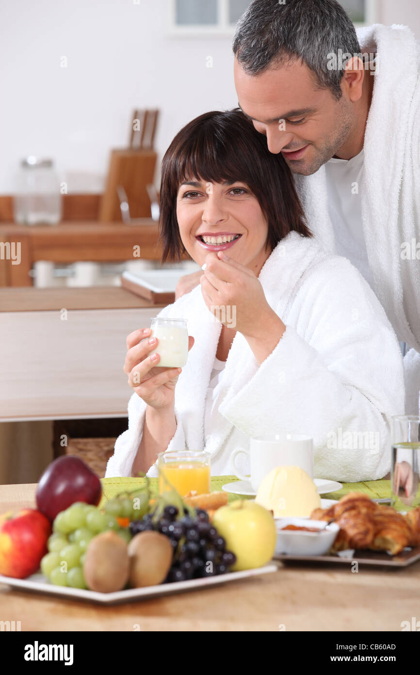 Couple in bathrobe having breakfast Stock Photo - Alamy