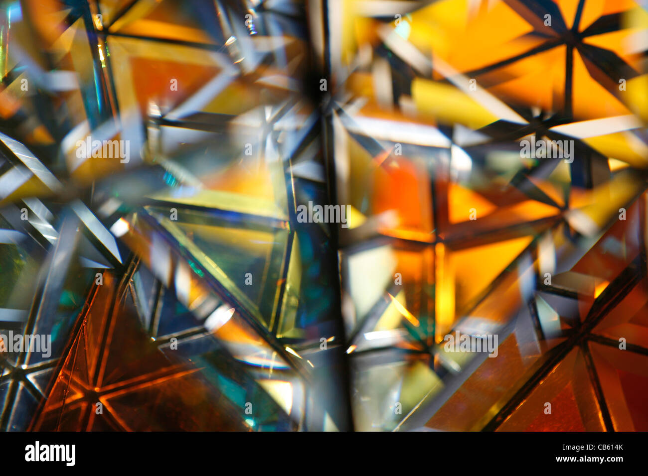 Crystal light shade with refracted coloured lights filtering through it. 3 Stock Photo