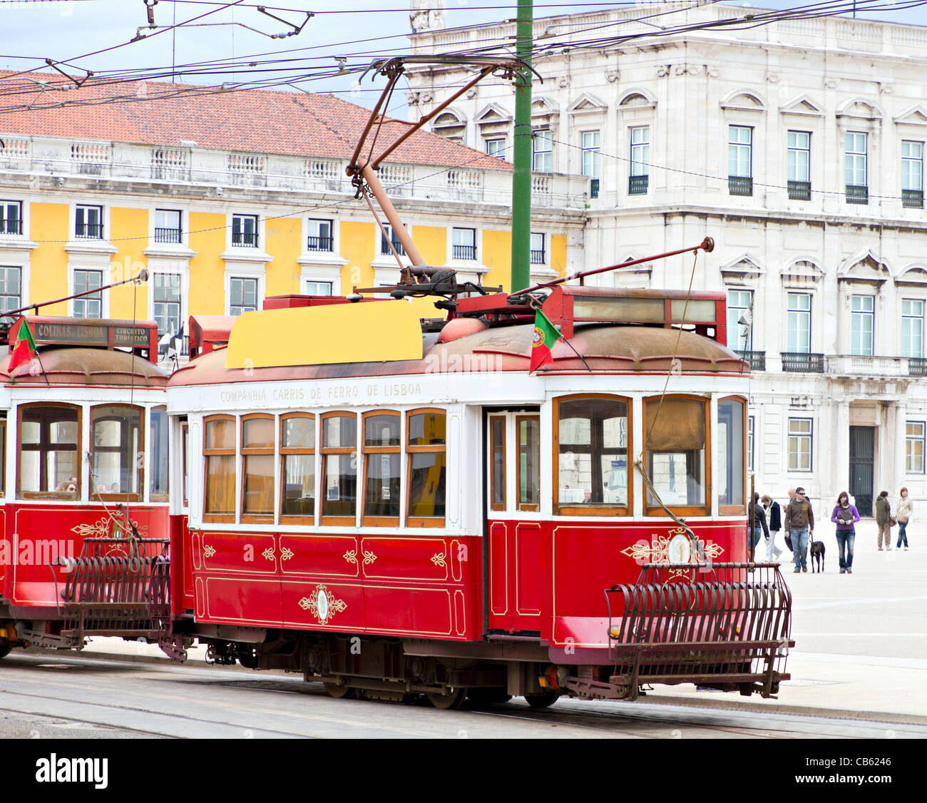 historic classic red tram of Lisbon built partially of wood in front of Lisbons central square Praca de Comercio, Portugal Stock Photo