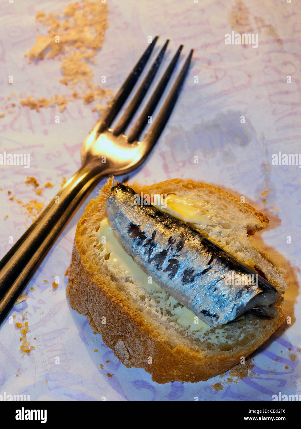 Tasty snack of sardine on slice of French bread. Stock Photo
