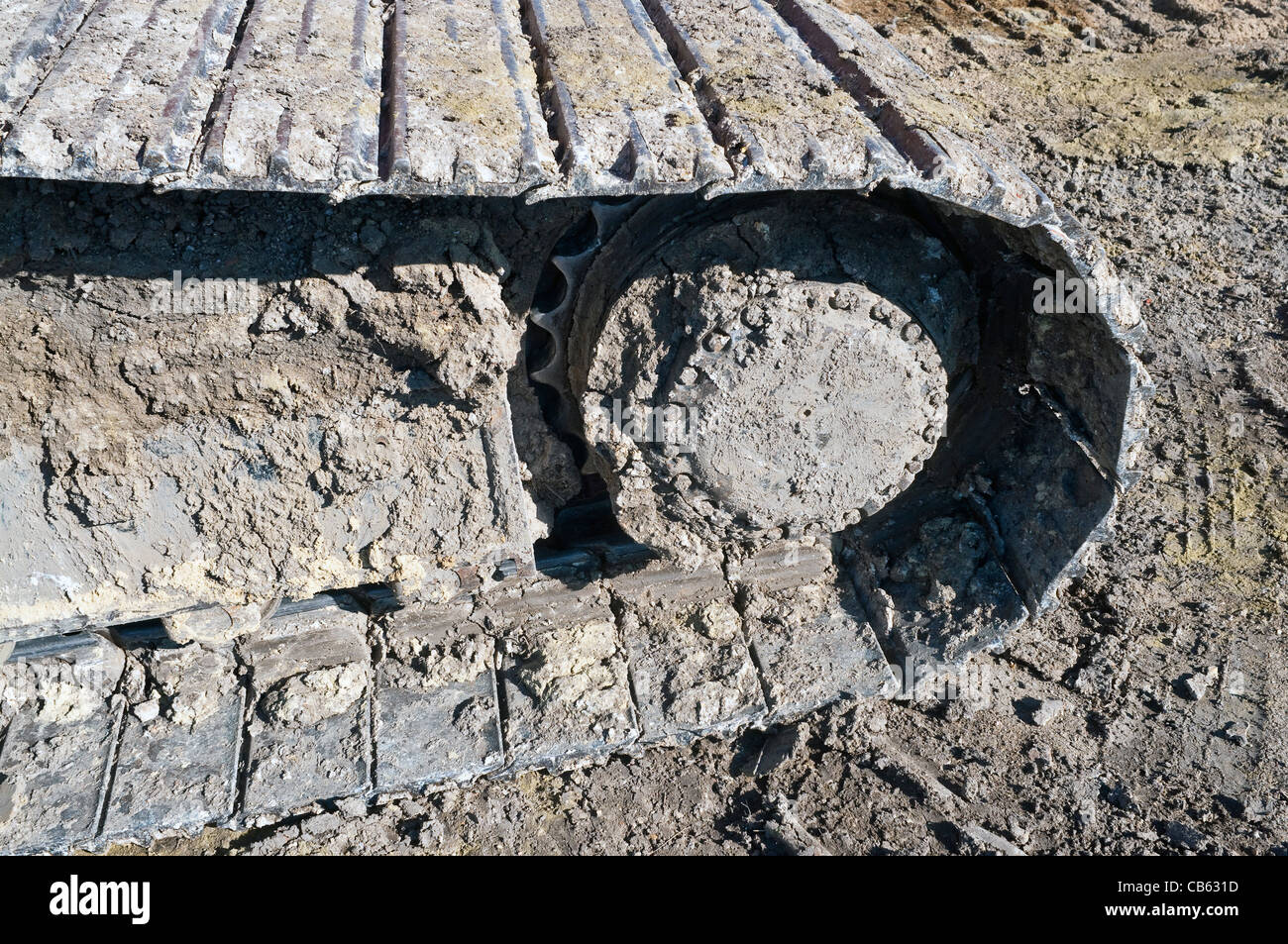 Mechanical digger muddy caterpillar track detail - France. Stock Photo