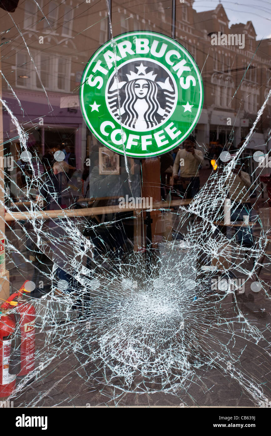 Aftermath of the summer riots and looting across London, where a Starbucks Coffee shop window was vandalised, Clapham London UK. Stock Photo