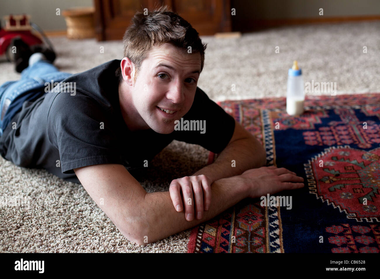 Happy father relaxing after playing with his baby. Stock Photo