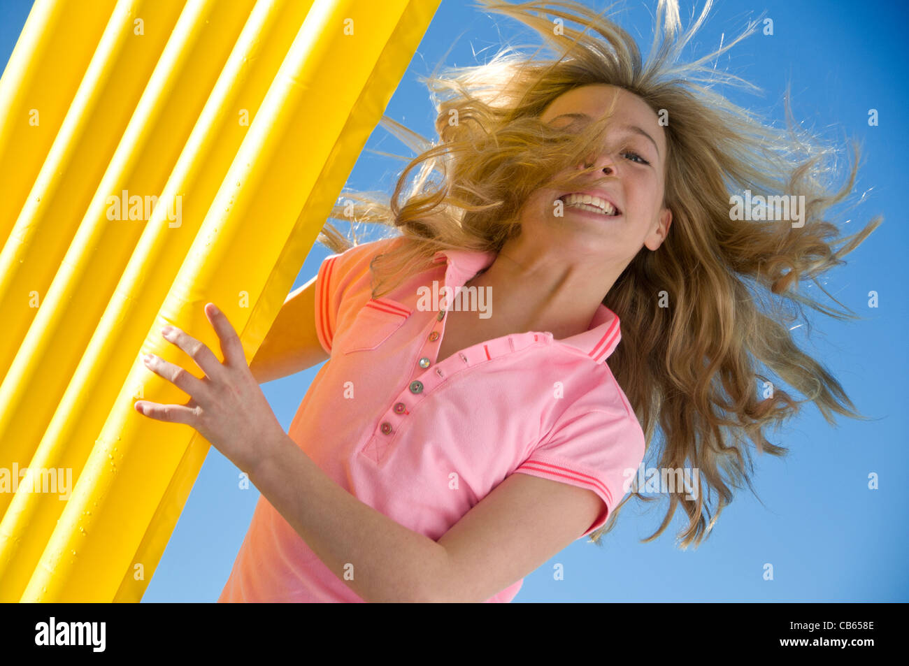 Fun moment holiday young teenage girl 13-16 years sun sky lilo Stock Photo