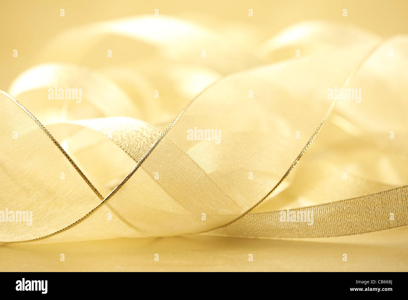 Closeup of wavy golden satin fabric ribbon,Shallow Dof. Stock Photo