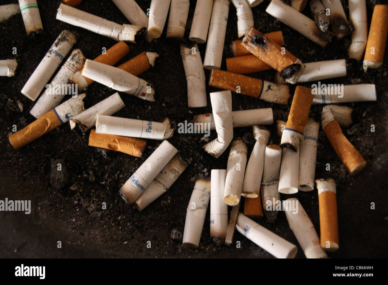 Cigarette butts in ashtray. Stock Photo