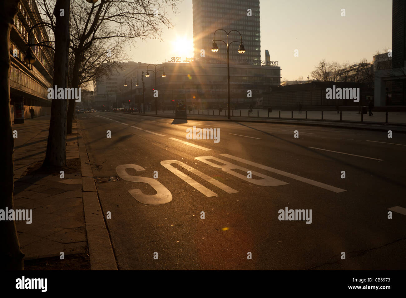 Berlin, Germany, March 02, 2011: Budapest street looking north towards zoo in the foggy sunny morning with a bus lane sign on the road Stock Photo