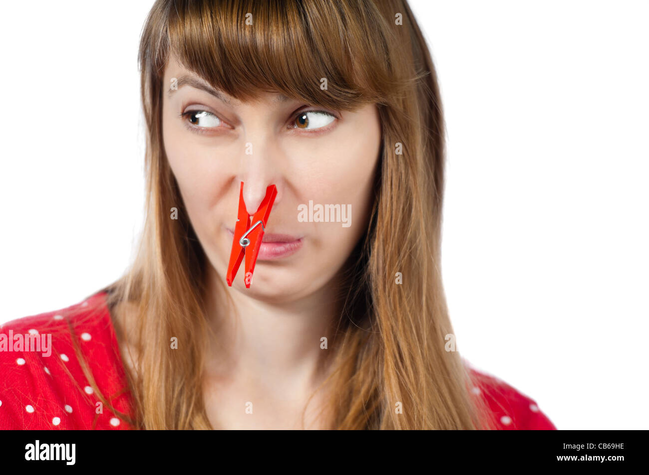 Beautiful young woman with red clothespin on her nose. Isolated on white background Stock Photo