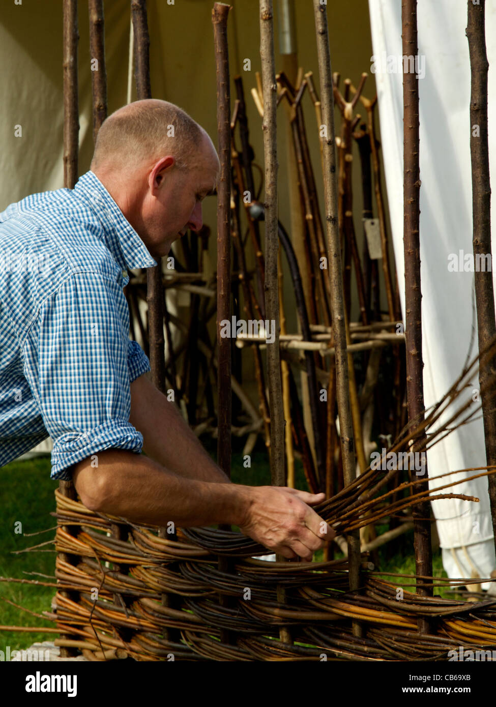 Traditional craftsman making willow hurdles Stock Photo
