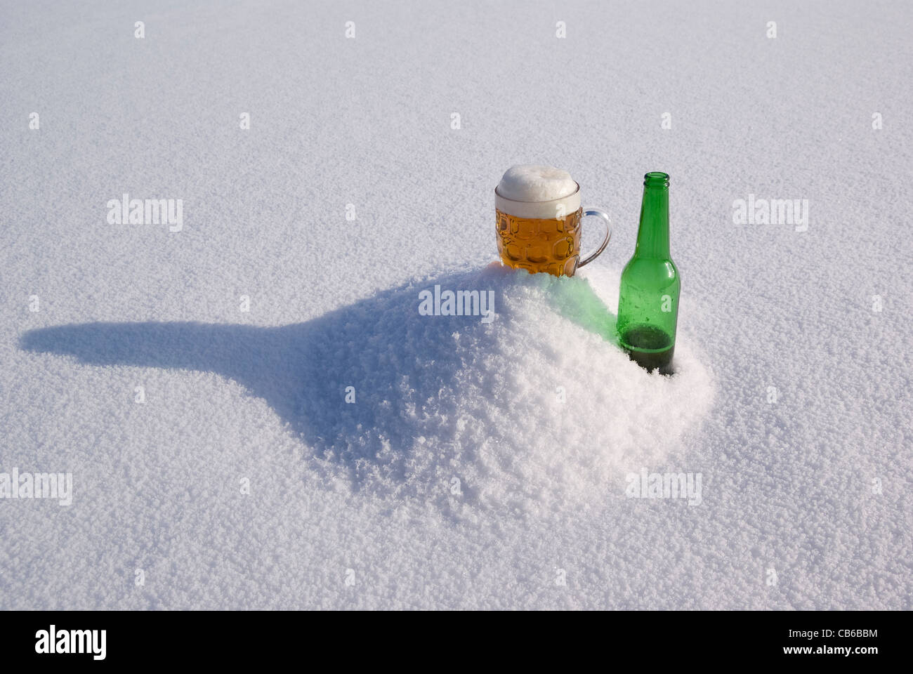 beer in glass and green bottle on snow Stock Photo