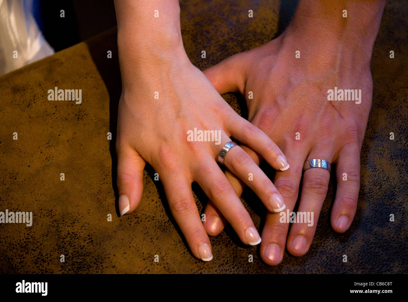 Hands of bride and groom showing their wedding rings Stock Photo Alamy