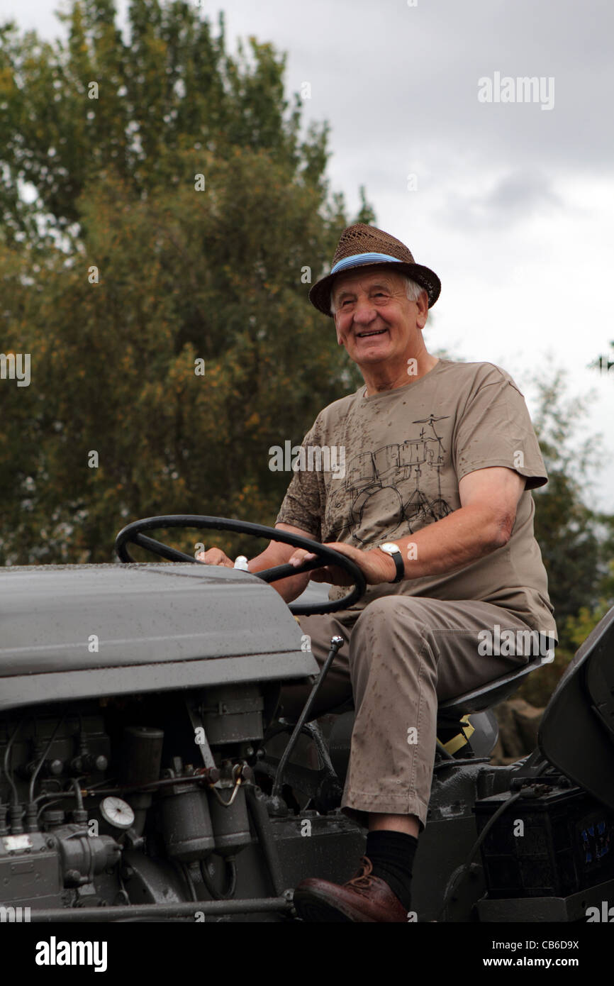 Man driving a tractor during Barlow Carnival parade in Derbyshire East