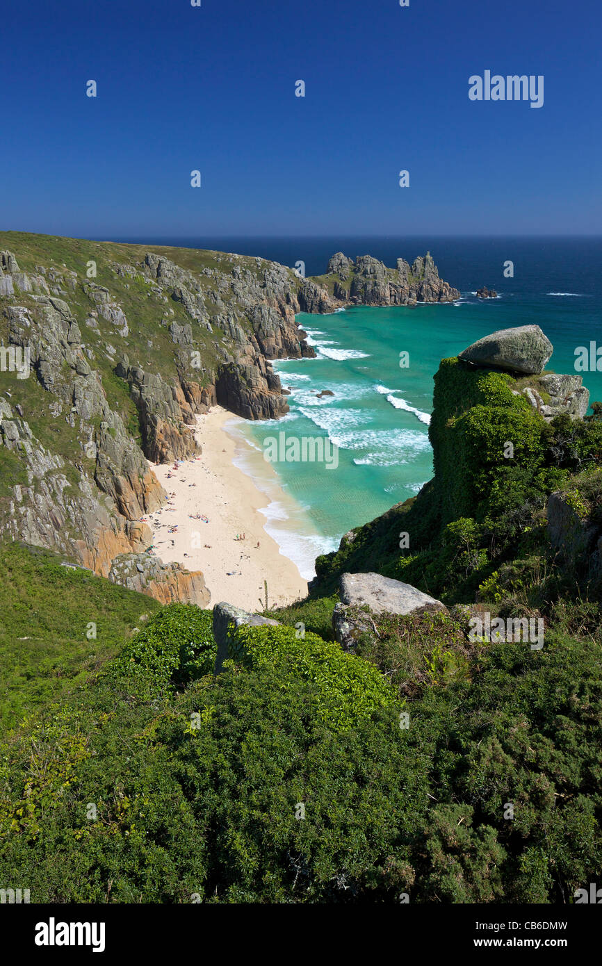 Surf and turquoise sea at Pednvounder beach in summer sunshine, Treen Cliff, near Porthcurno,  Lands End Peninsula, Cornwall Stock Photo