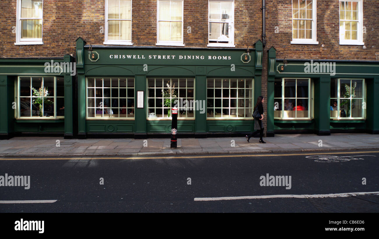 A woman walking past Chiswell Street Dining Rooms restaurant London England UK Stock Photo