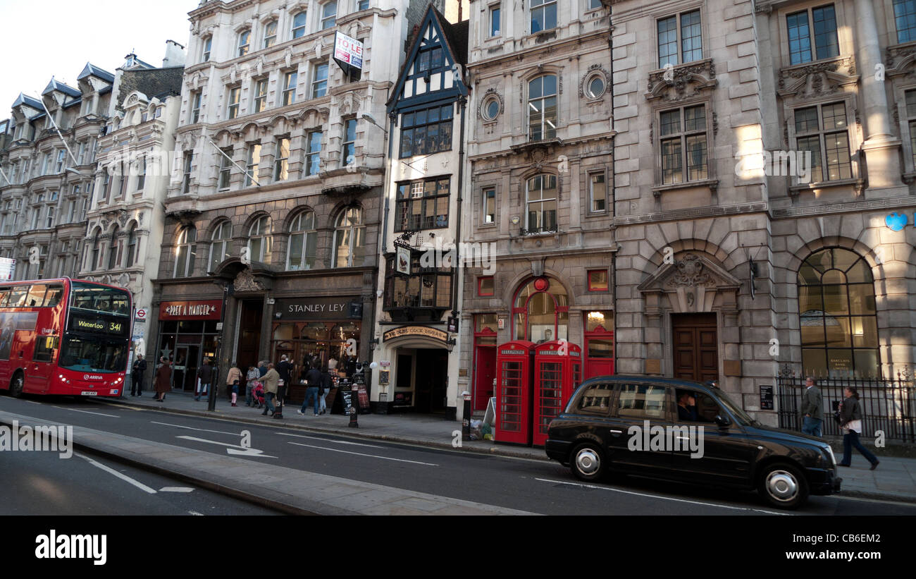 A view of red bus, black taxi cab and building facade on historic buildings on Fleet Street in London England UK  Great Britain KATHY DEWITT Stock Photo