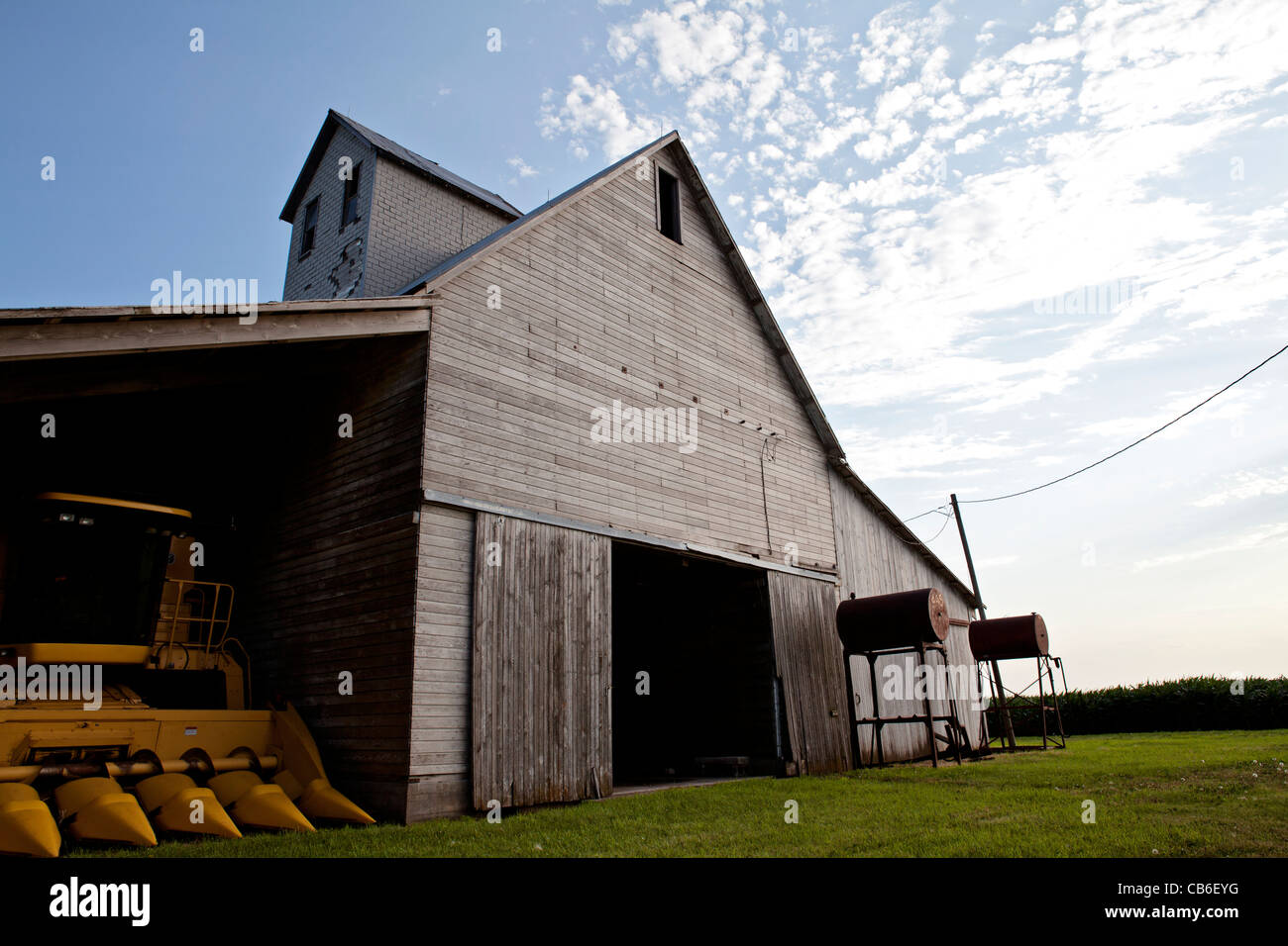 Old barn on farm with gas pumps and blue sky with clouds. Iowa. Midwest.  Combine Stock Photo - Alamy