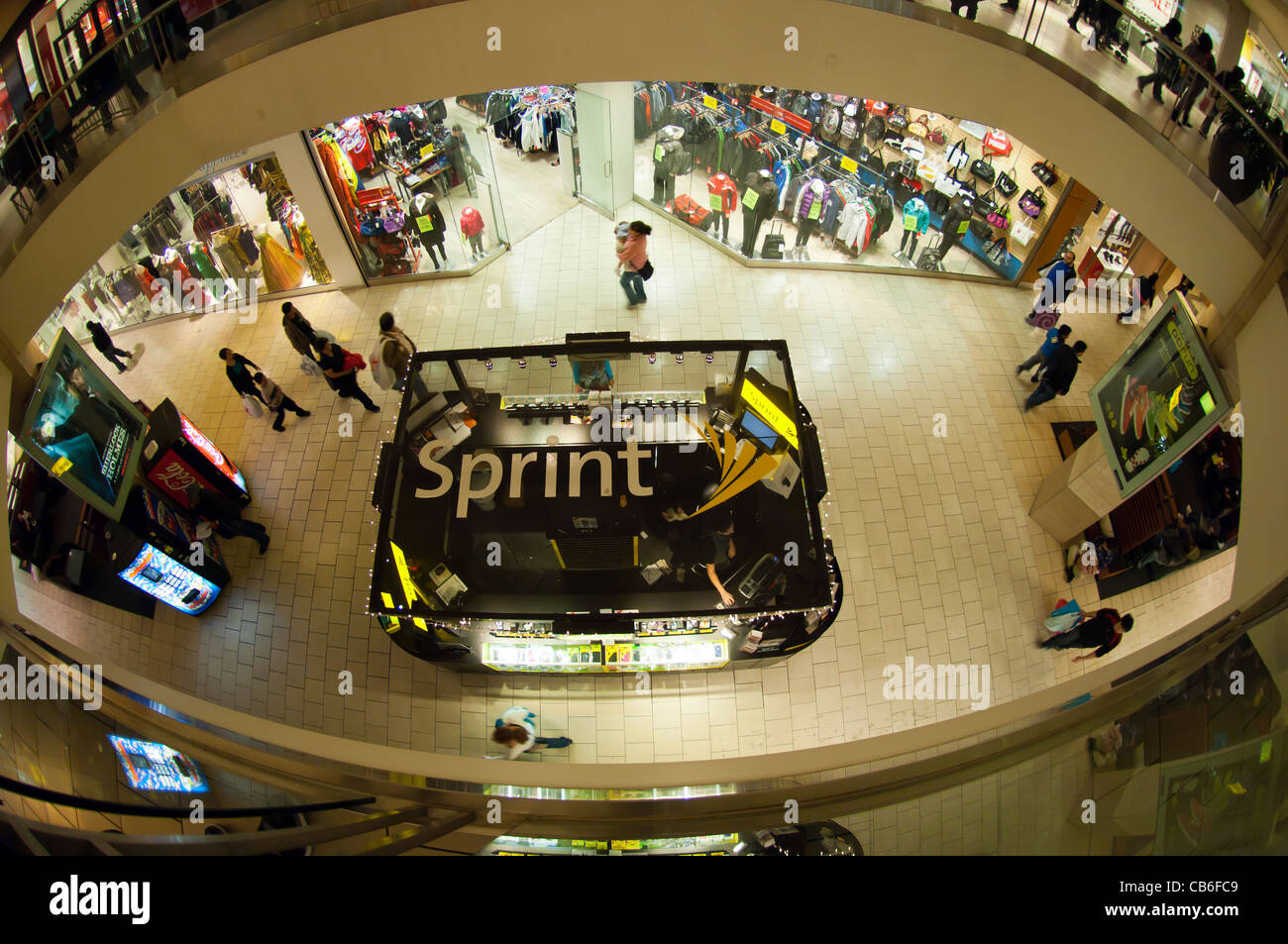 Shoppers pass a Sprint kiosk at a mall in the borough of Queens in New York Stock Photo