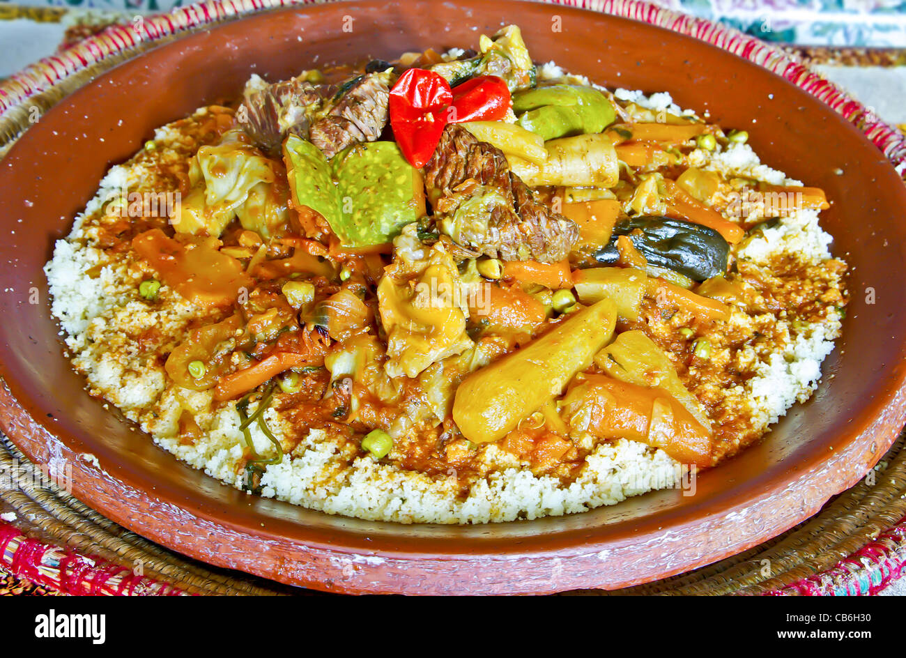 Moroccan couscous served in the ceramic dish the traditional way Stock