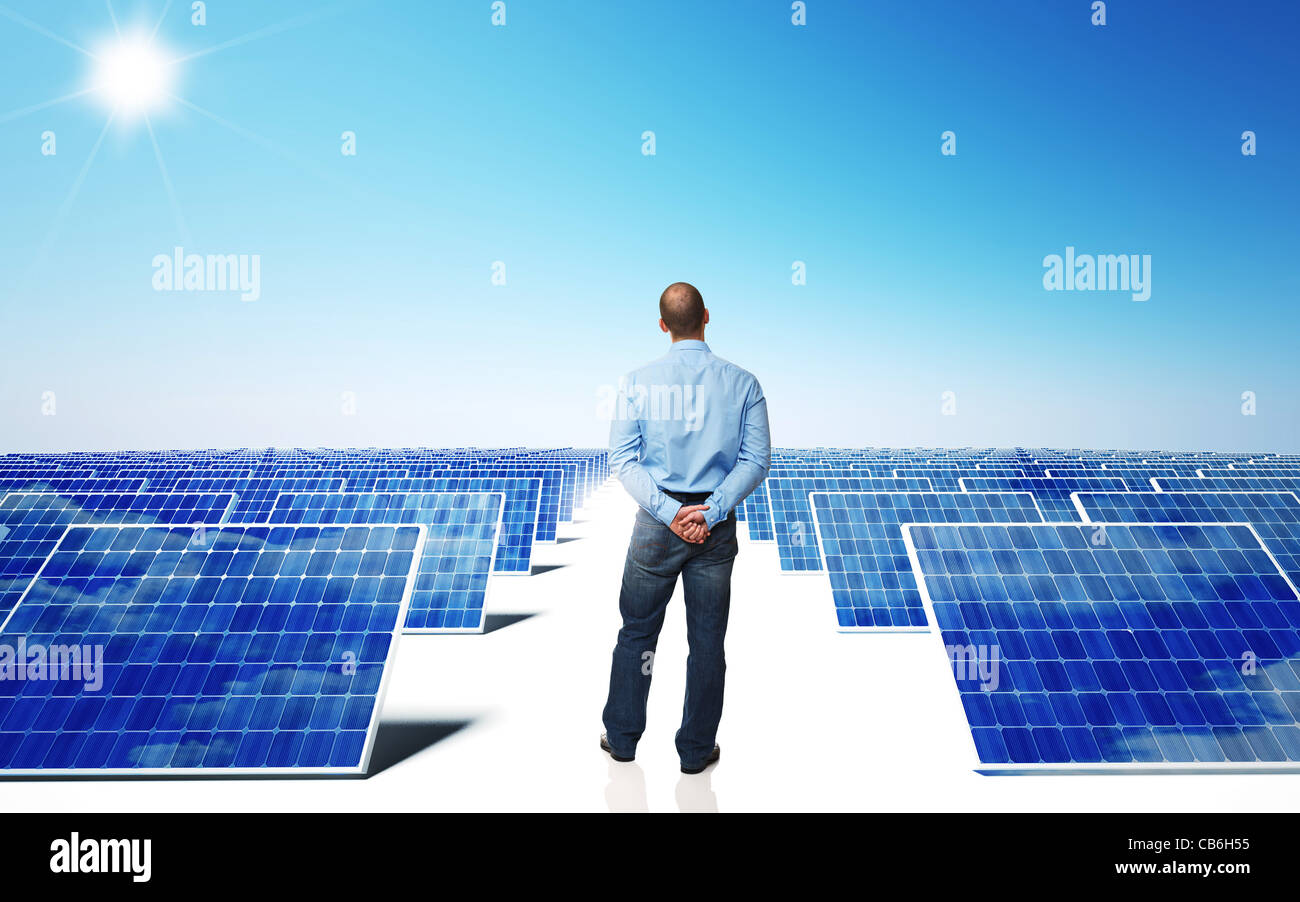 lots of solar panel and blue sky with man back view Stock Photo