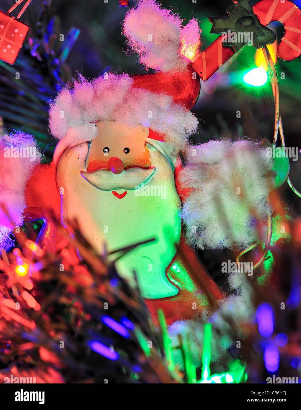 Christmas tree decoration of Santa Claus surrounded by tinsel and fairy lights Stock Image