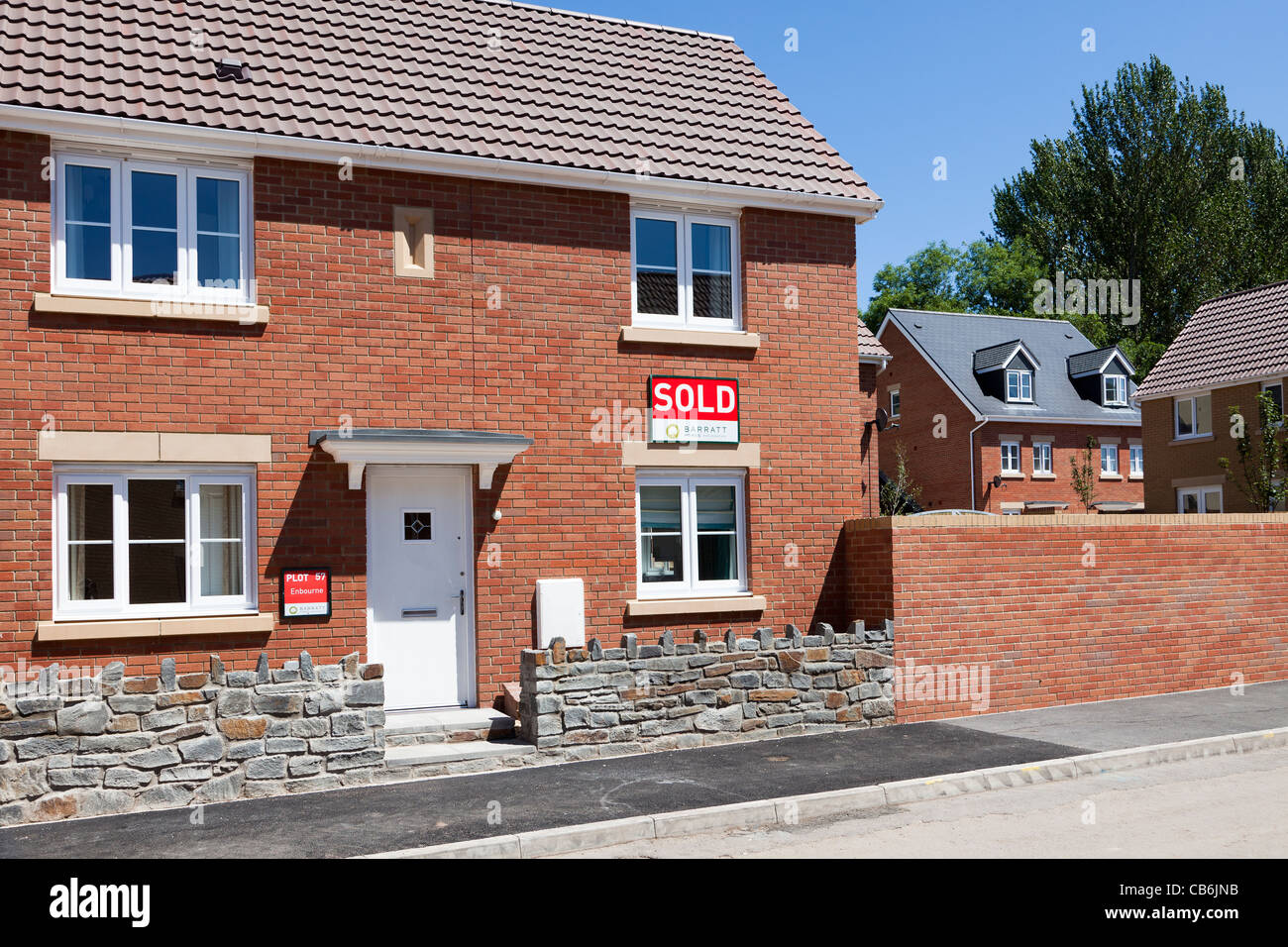 New house with sold sign on new Barratt estate Abergavenny Wales UK Stock Photo