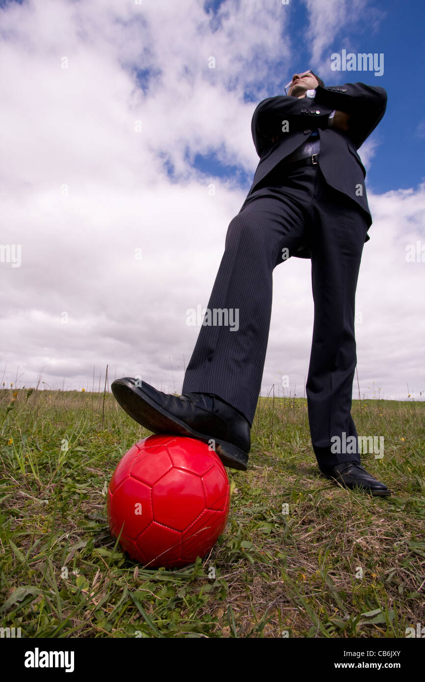 businessman holding a soccer ball in the field Stock Photo - Alamy