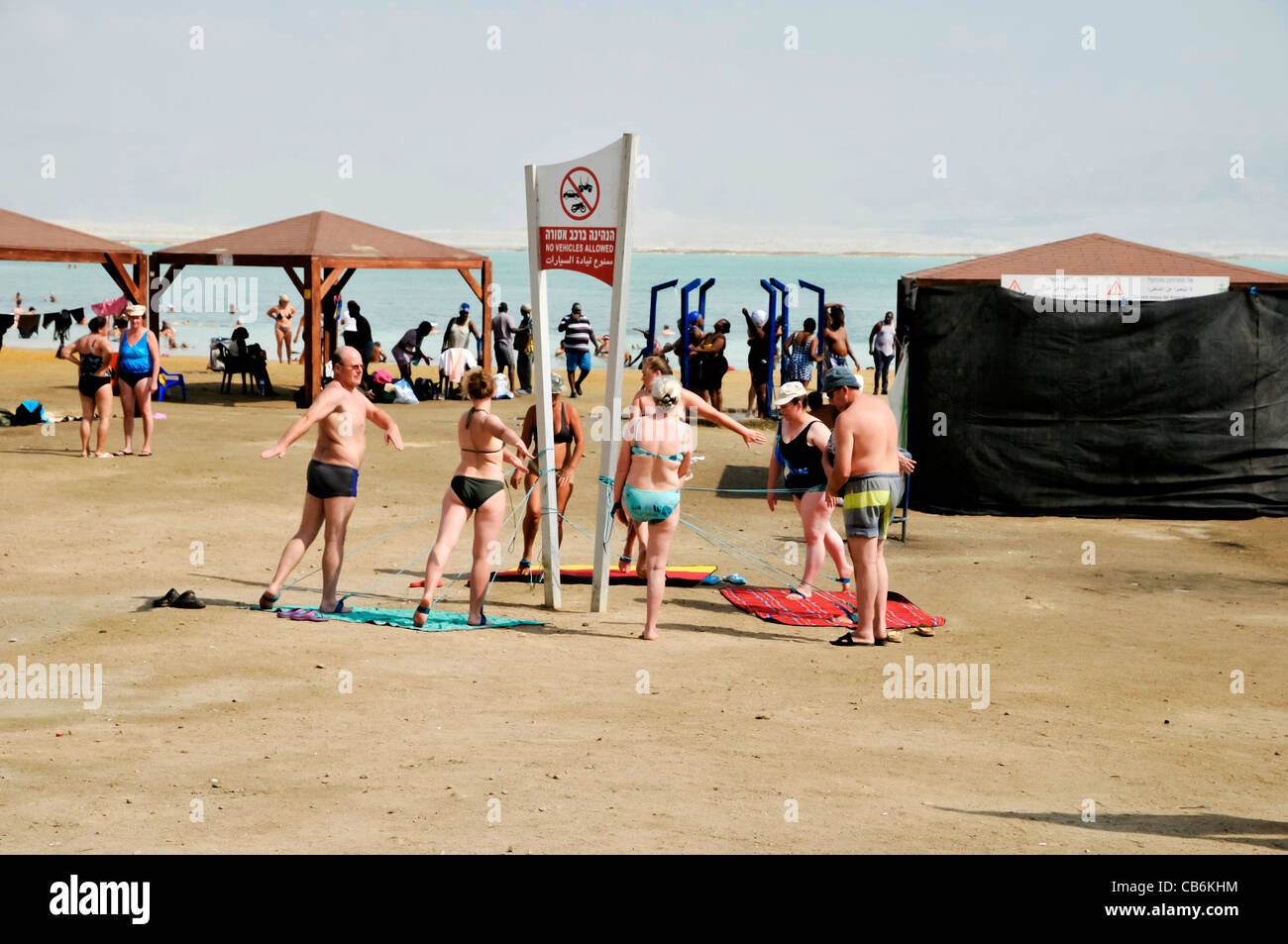 Resort guests elderly men and women doing  therapeutic exercise,Dead Sea beach, Israel, Asia Stock Photo