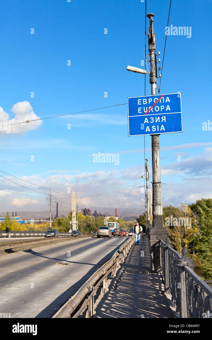 Road sign about Europe and Asia border in Ural river. It is located on vehicular bridge in city. Ural, Magnitogorsk, Russia. Stock Photo