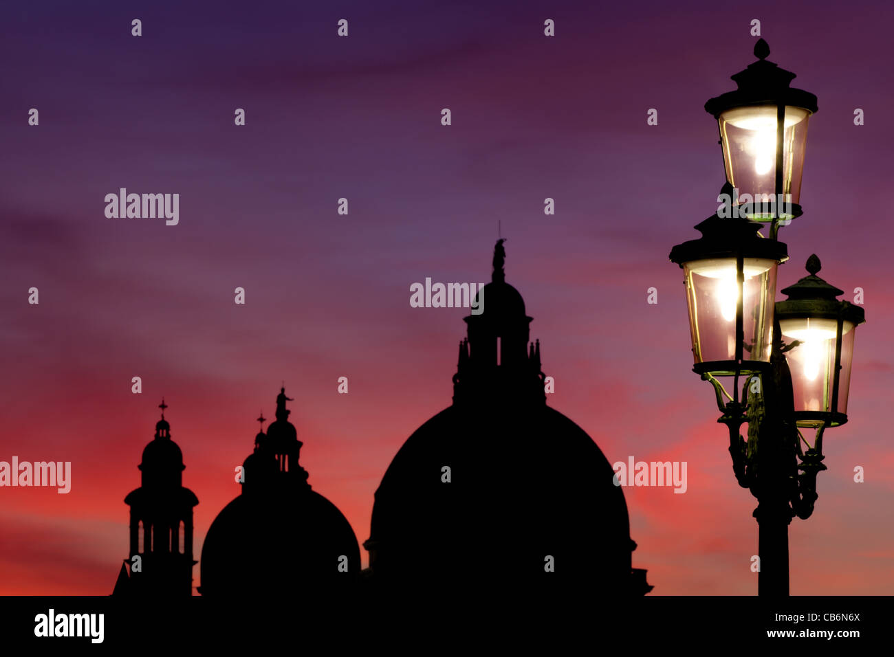 Lamp post in front of the church Santa Maria della Salute at sunset, Venice, Veneto, Italy Stock Photo