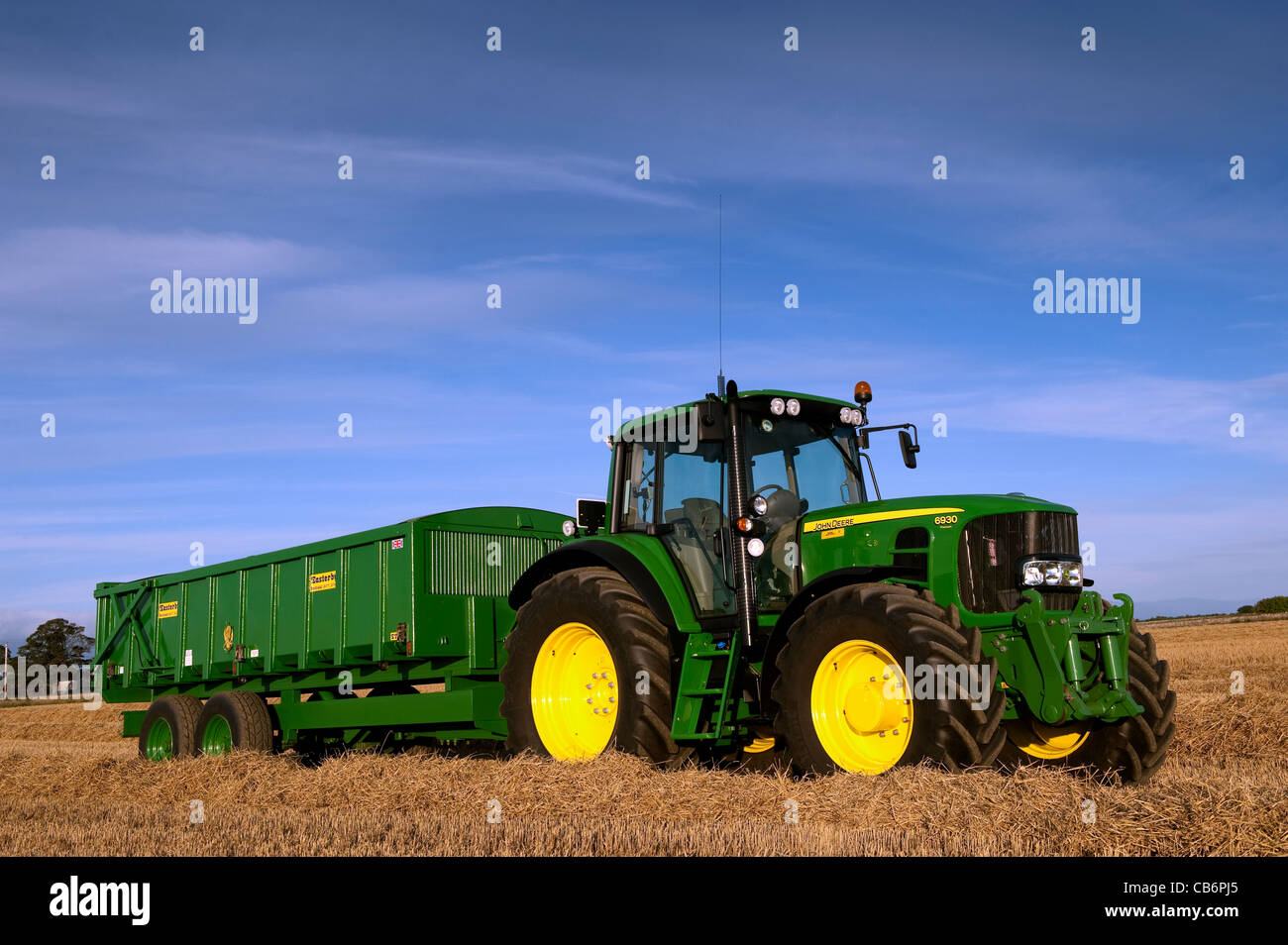 John Deere 6930 tractor with 10 tonne grain trailer on. Stock Photo