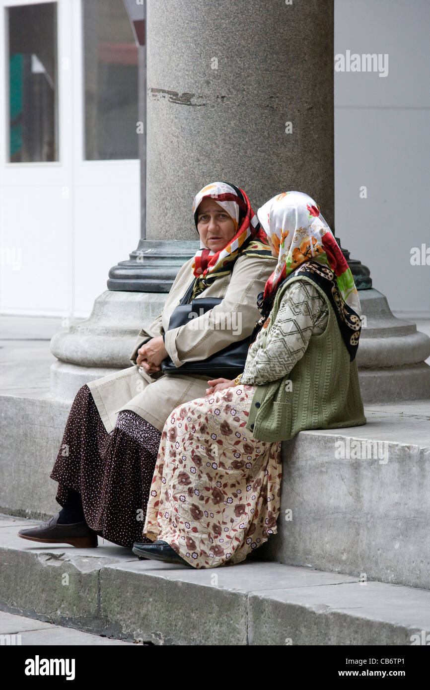 Istanbul Blue Mosque Muslim women in headscarves sit on the steps
