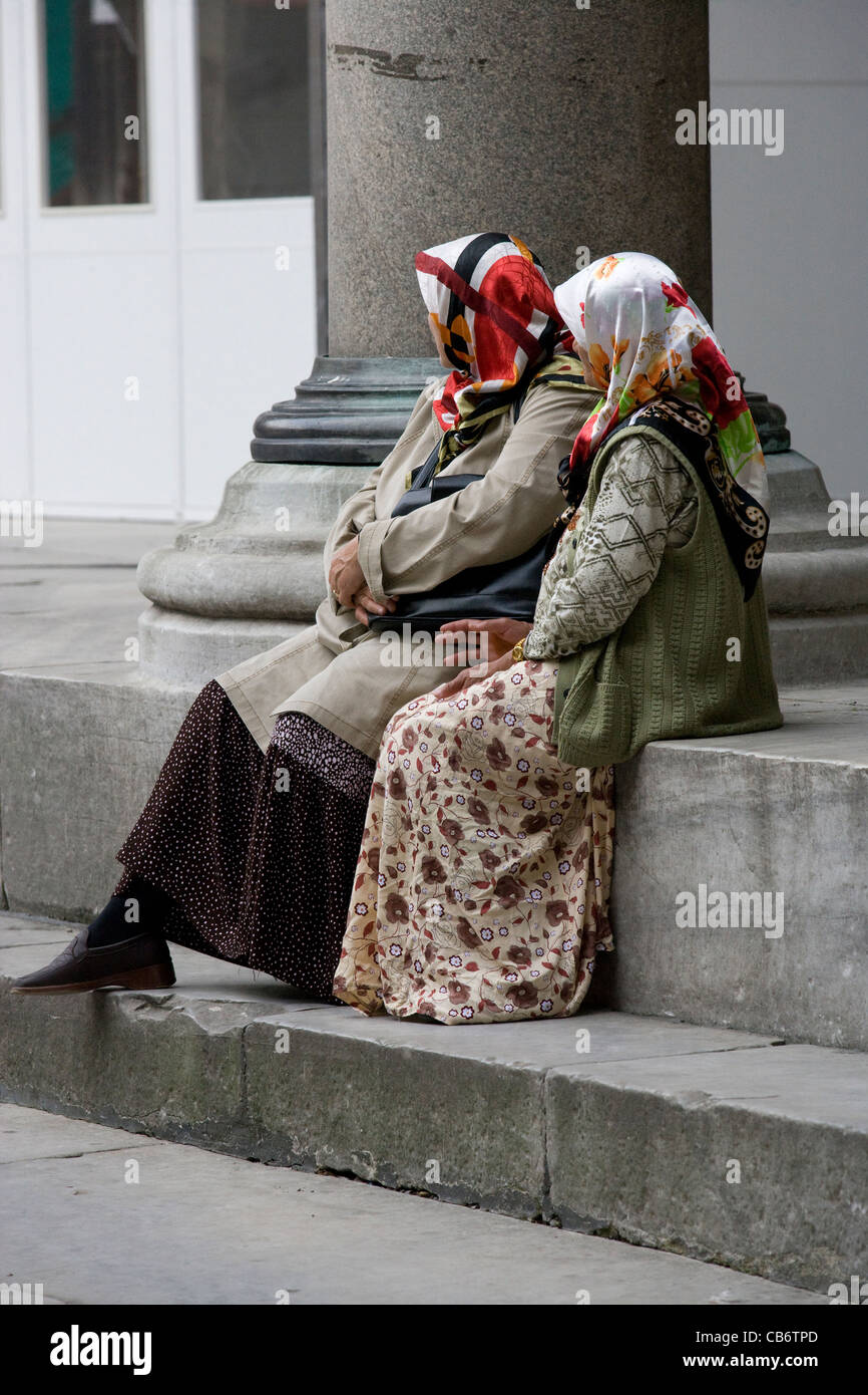 Istanbul Blue Mosque Muslim women in headscarves sit on the steps