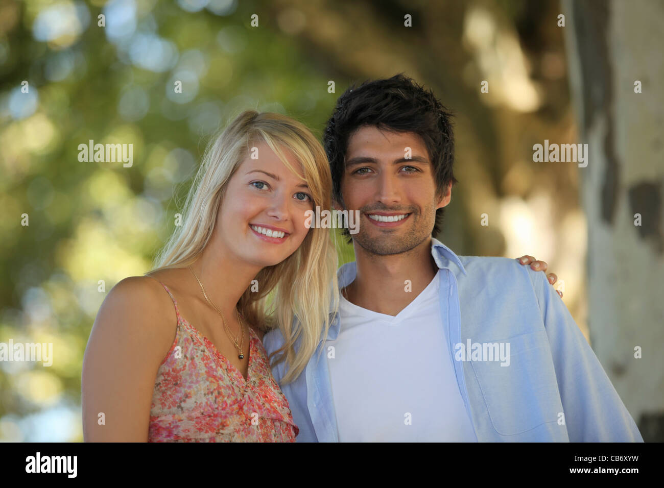 Happy couple having a walk in the woods Stock Photo - Alamy