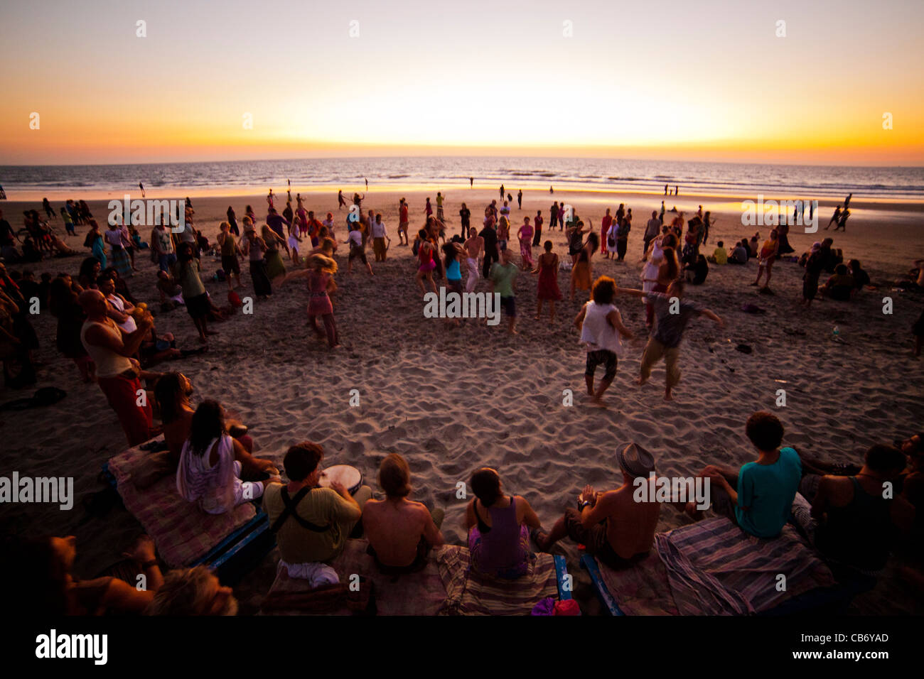 goa shore sunset dance drum sea motion merriment Stock Photo