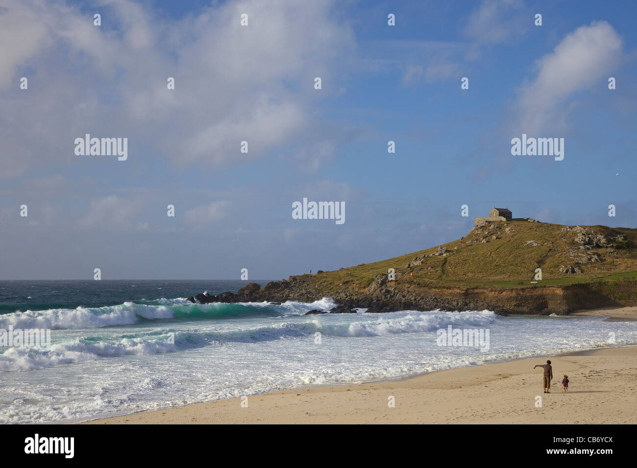 Father and young daughter watch rough seas off Porthmeor beach, St Ives, Cornwall, Southwest England, UK, United Kingdom, GB Stock Photo