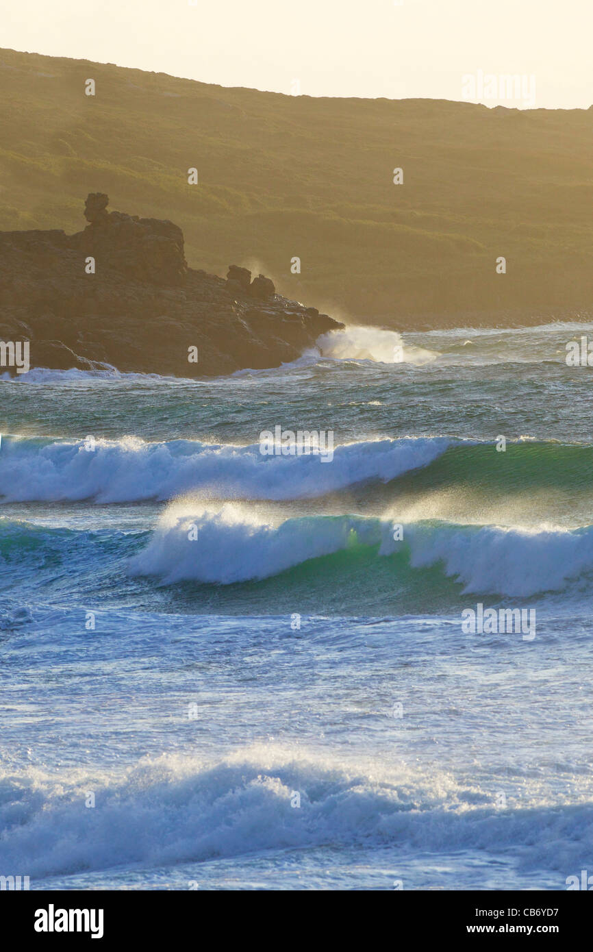 Surf in rough seas off Porthmeor beach in evening sun, St Ives, Cornwall, Southwest England, UK, United Kingdom, GB Stock Photo