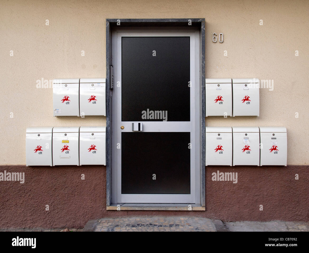 Mailboxes next to door Stock Photo