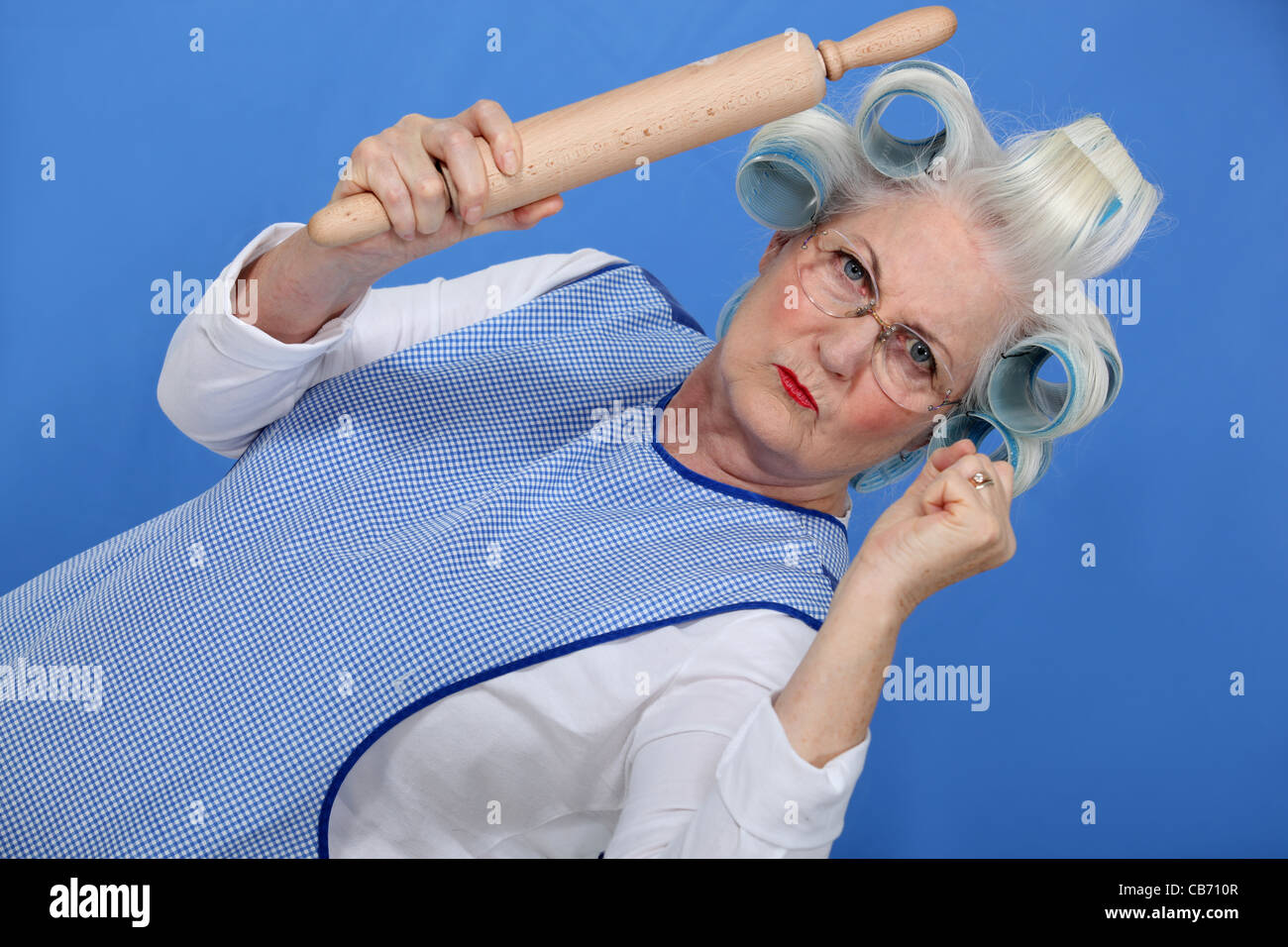 Angry old lady with rolling pin Stock Photo