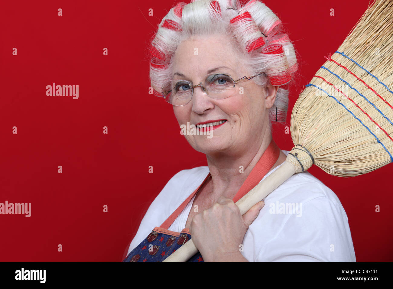 https://c8.alamy.com/comp/CB7111/an-old-lady-with-hairroller-on-and-a-broom-CB7111.jpg