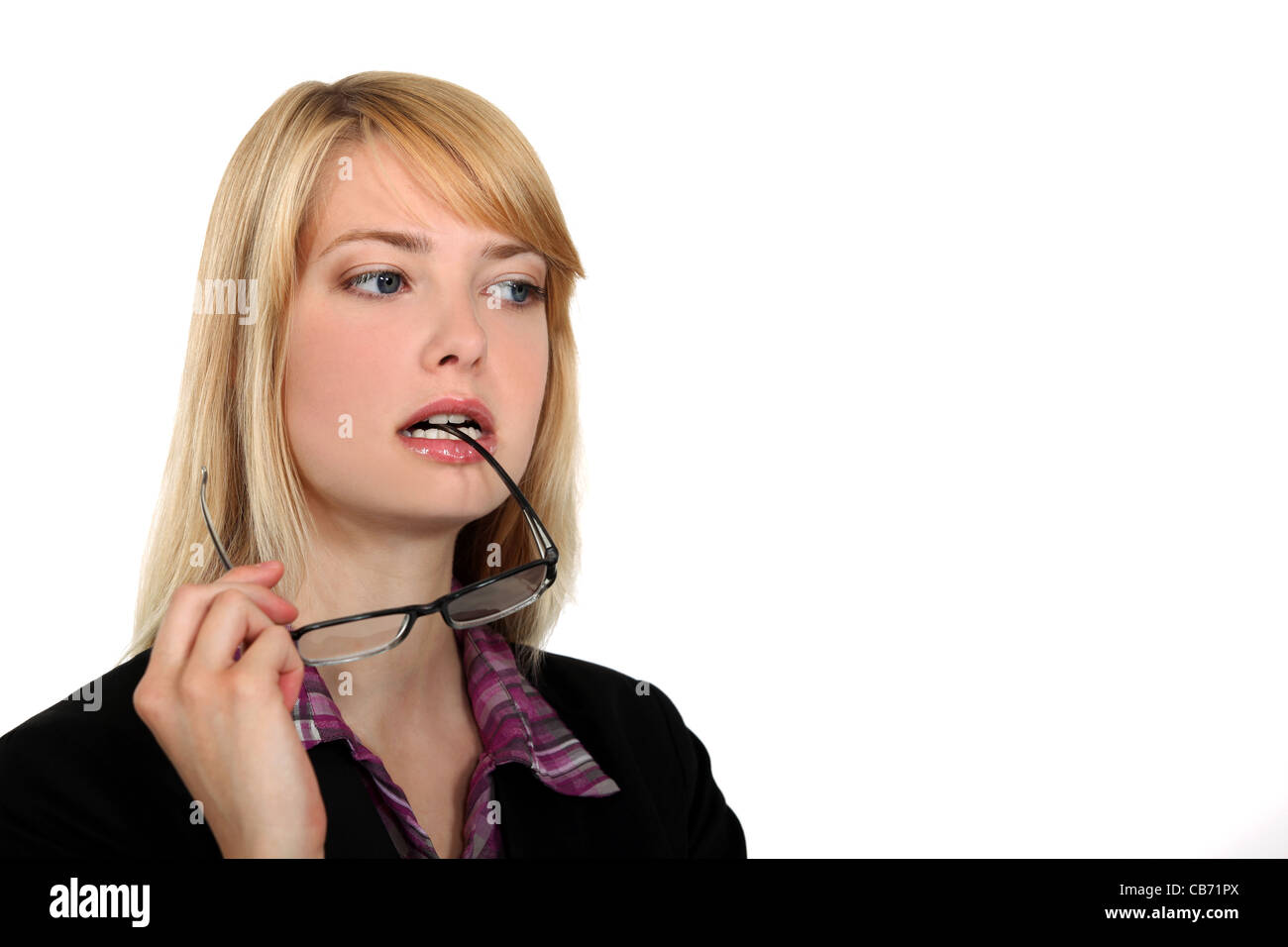 Attractive woman chewing on her glasses Stock Photo Alamy