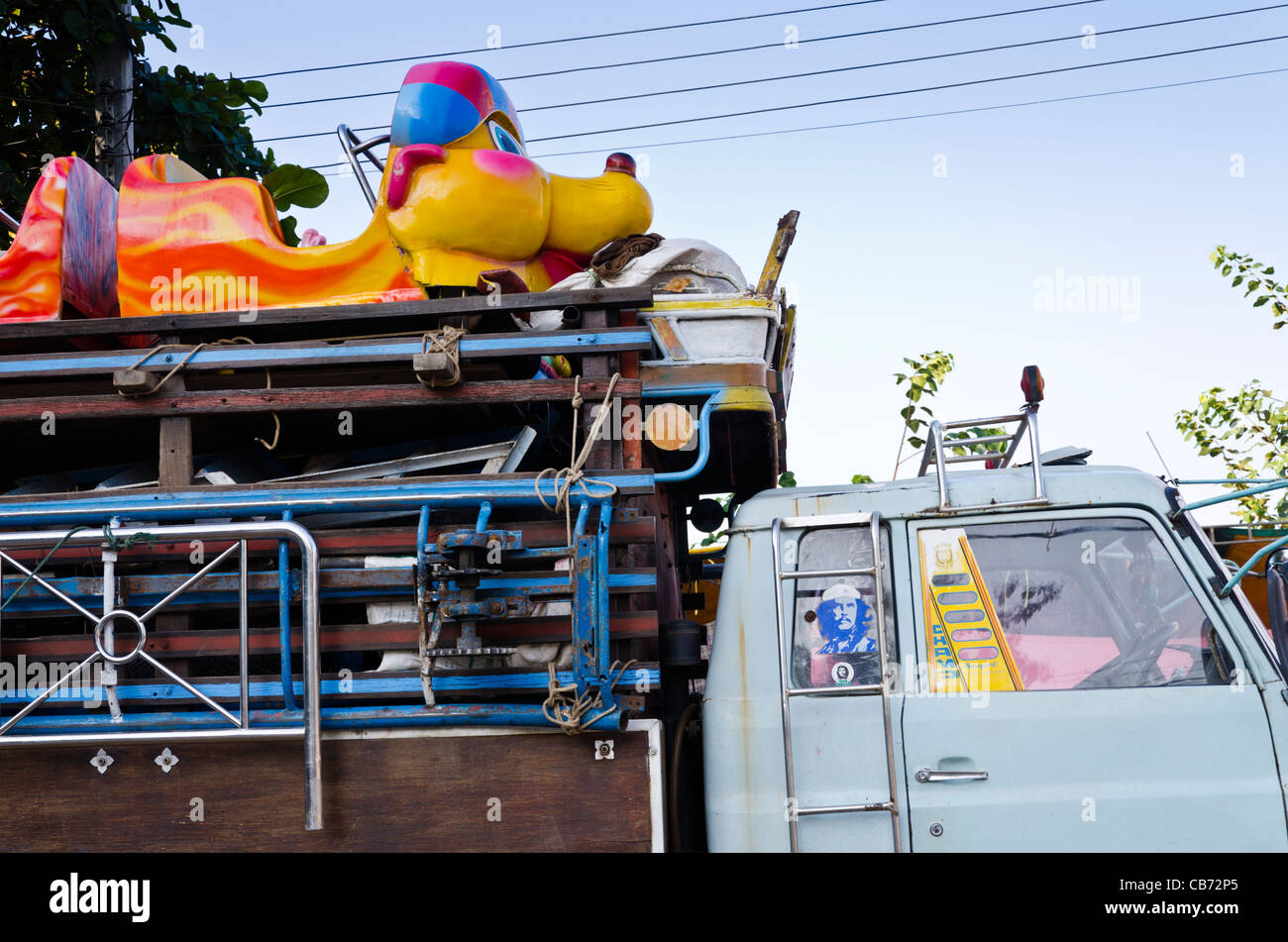 Truck with large sculpted animal head of entertainment ride on top and
