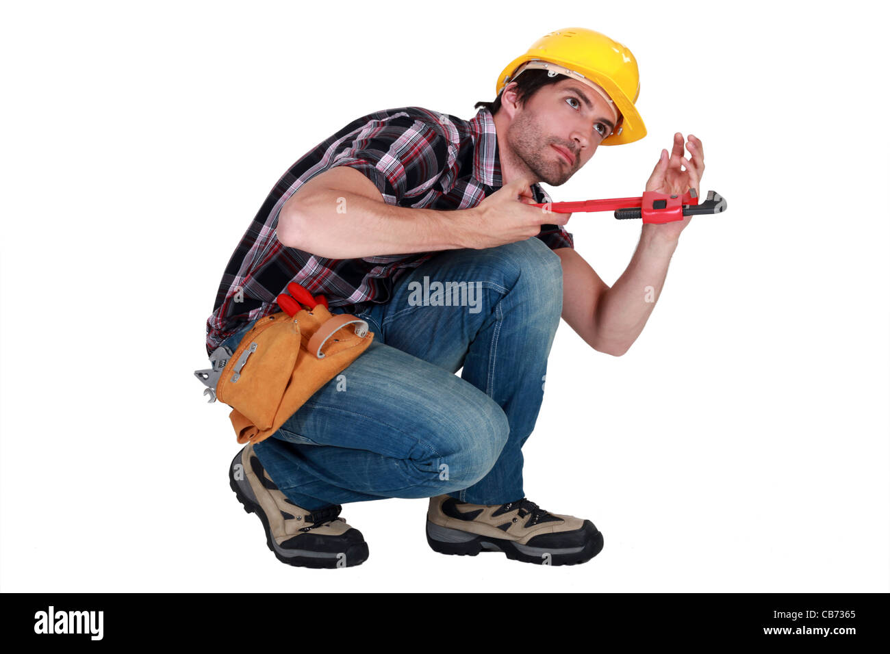Man using a pipe wrench to tighten a pipe Stock Photo Alamy