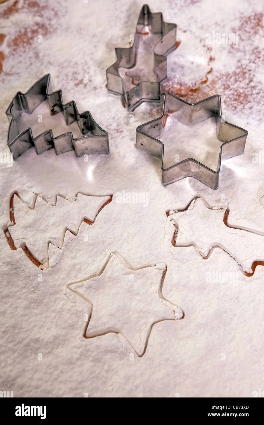 Cookie cutters in flour Stock Photo