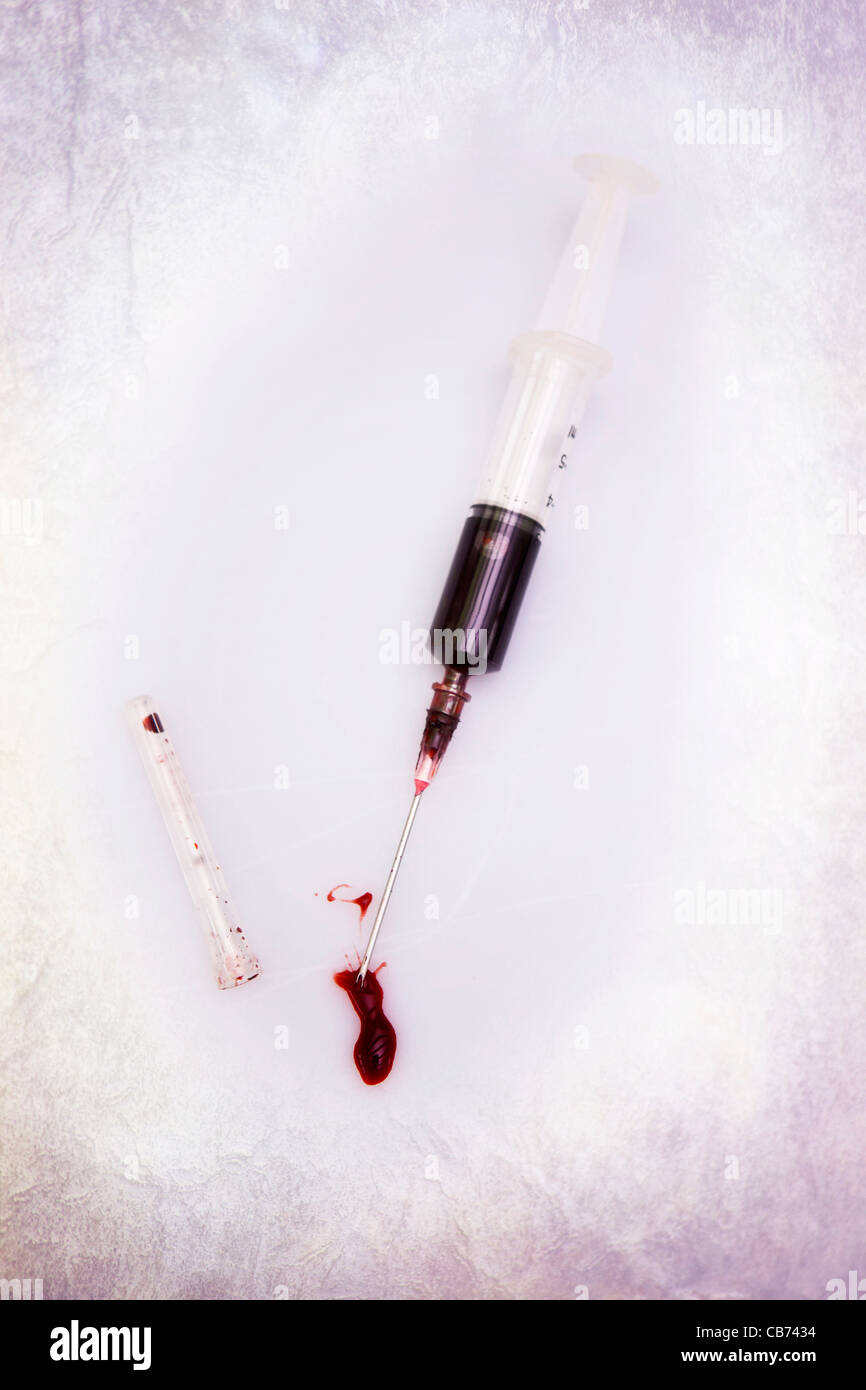 a syringe filled with blood Stock Photo