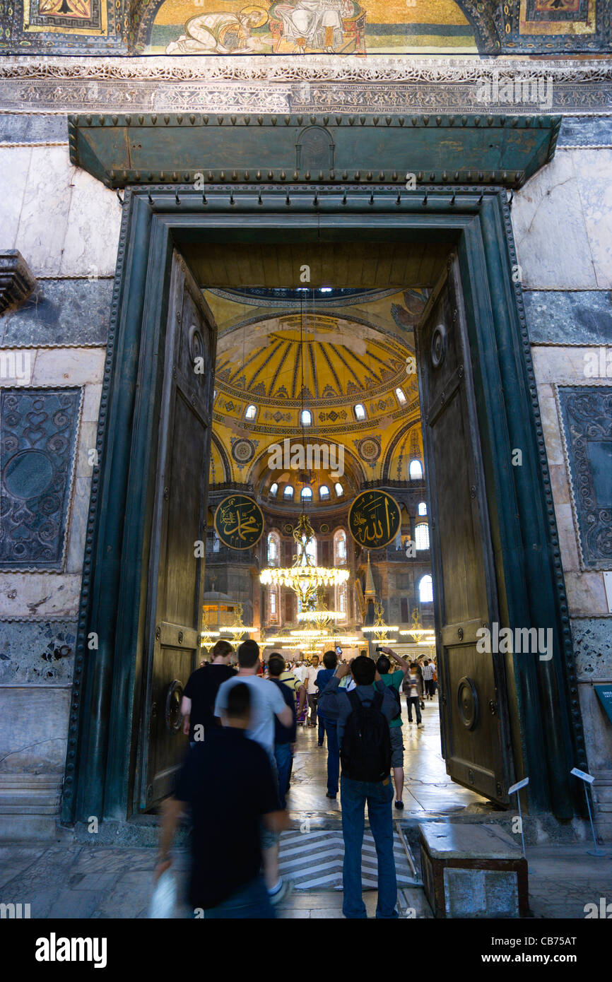 Turkey, Istanbul, Sultanahmet, Haghia Sophia People walking through the Imperial Gate with mosaics above and church nave beyond Stock Photo
