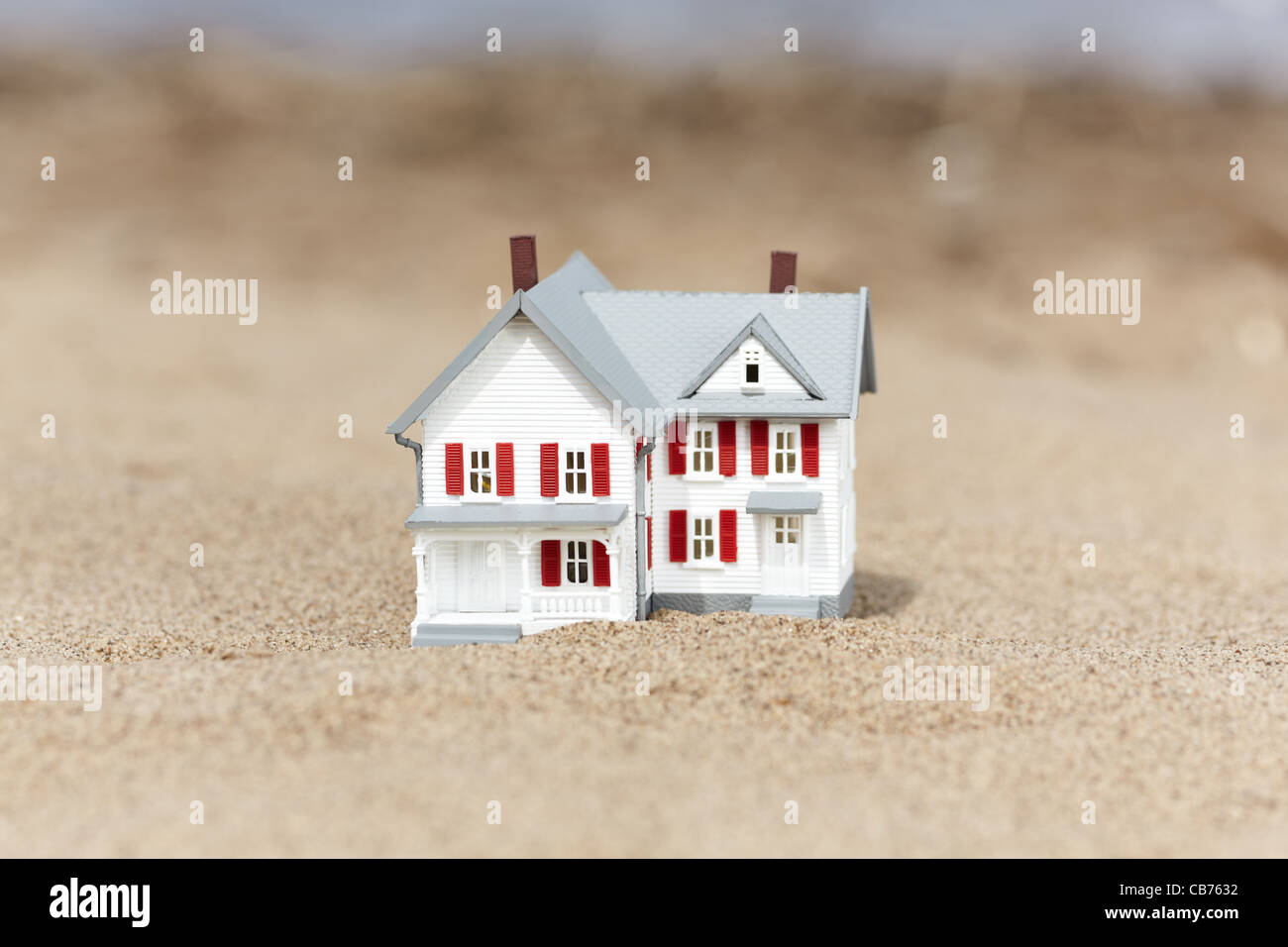 Artificial model of the cottage on the sand, selective focus Stock Photo