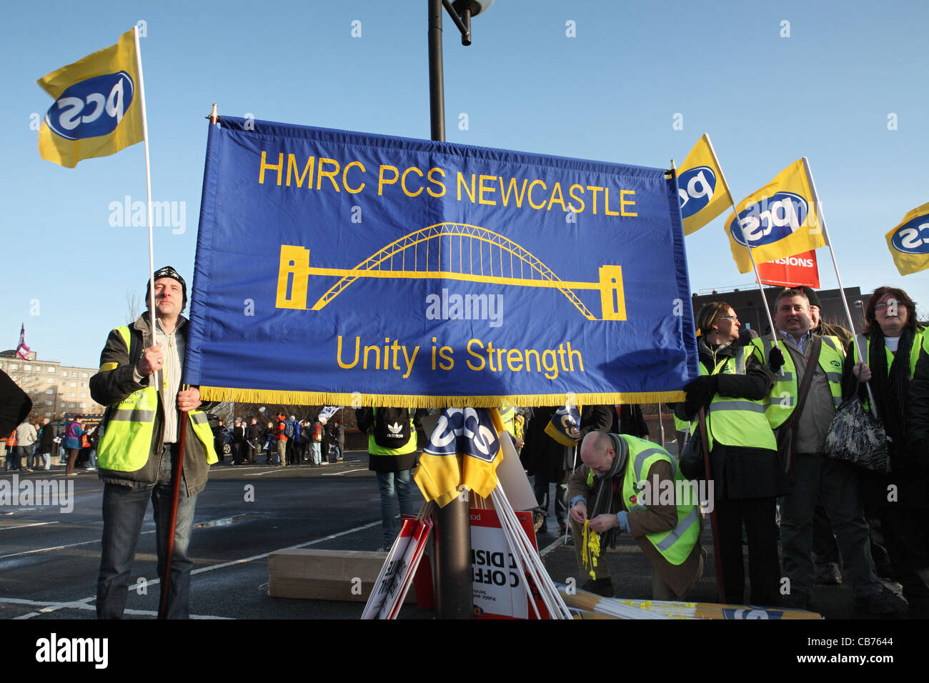 Striking workers hold HMRC PCS banner and flags, TUC day of action Gateshead, north east England, UK Stock Photo